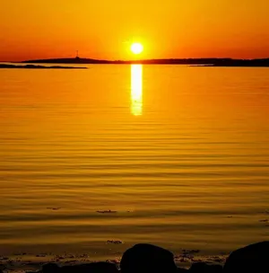 Yellow Sunset Over Tranquil Waters Wallpaper
