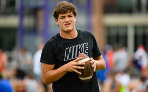 Young Athlete Holding Football Wallpaper