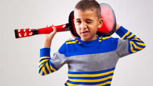 Young Boy With Toy Guitar Wallpaper