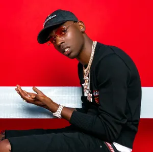 Young Dolph Wearing A Luxurious Fur Coat Wallpaper