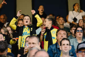 Young Fans Cheeringat Football Match Wallpaper