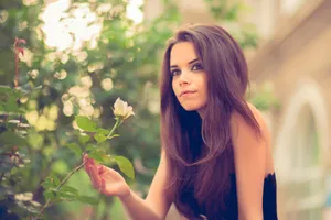 Young Female Model Holding Rose Wallpaper