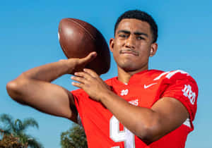 Young Football Quarterback Pose Wallpaper