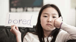 Young Girl Expressing Reluctance And Boredom Wallpaper