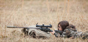 Young Girl In The Forest, Aiming Her Rifle. Wallpaper