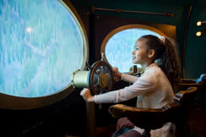 Young Girl Steering Ship Simulator Ontario Science Centre Wallpaper