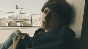 Young Man Leaning Against Window Wallpaper