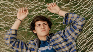 Young Man Lyingon Hammock Wallpaper