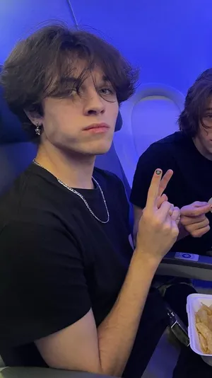 Young Man Peace Sign Airplane Cabin Wallpaper