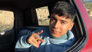 Young Man Peace Sign Car Window Wallpaper