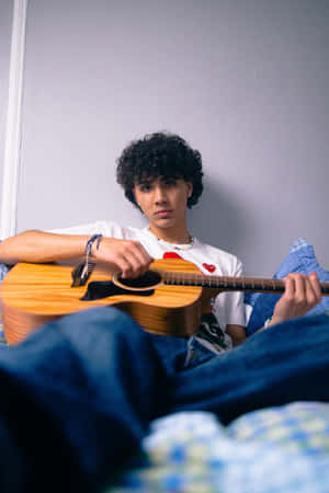 Young Musicianwith Guitar Wallpaper