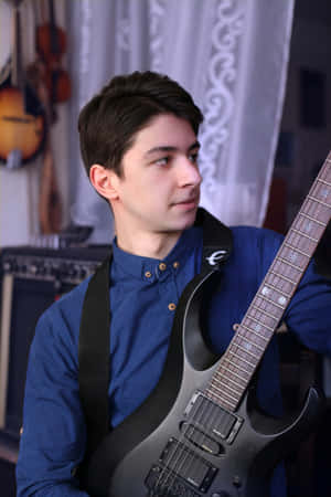 Young Musicianwith Guitar Wallpaper