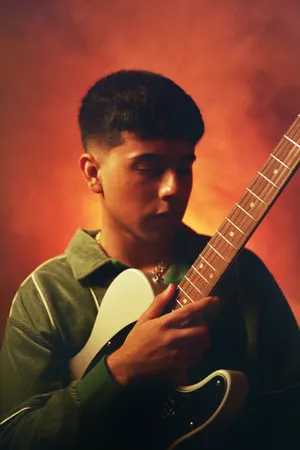 Young Musicianwith Guitar Wallpaper