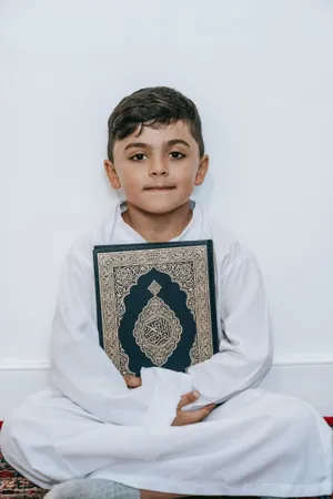 Young Muslim Boy Holding Quran Book Wallpaper