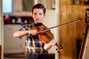 Young Sheldon Playing Violin Wallpaper