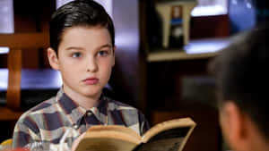 Young Sheldon Reading Book Wallpaper