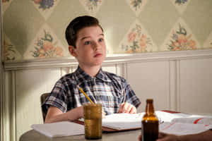 Young Sheldon Studyingat Home Wallpaper