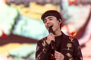 Young Singer Performingon Stage Wallpaper