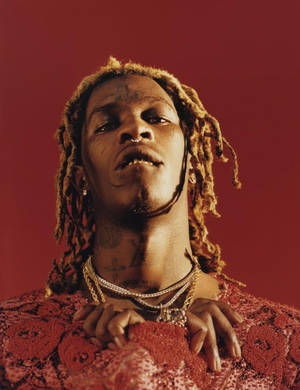 Young Thug Posing By A Red Phone Wallpaper