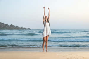 Young Woman In Trendy Summer Outfit Enjoying The Sun Wallpaper