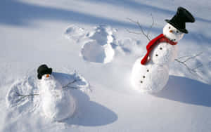 Young Woman Making A Snow Angel In Winter Wonderland Wallpaper