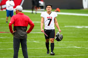 Younghoe Koo Atlanta Falcons Kicker Walkingon Field Wallpaper