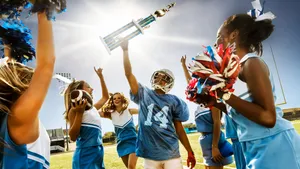 Youth Football Team Celebrationwith Cheerleaders Wallpaper