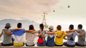 Youth Group Enjoying Seaside View Wallpaper