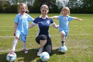 Youth Soccer Coachand Players Balancingon Balls.jpg Wallpaper