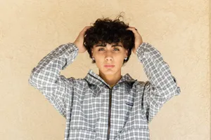 Youthful Curly Haired Individual Wallpaper