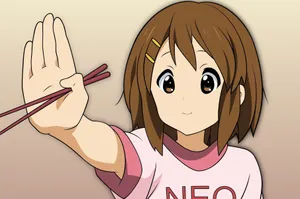 Yui Hirasawa Playing Guitar In A Captivating Moment Wallpaper