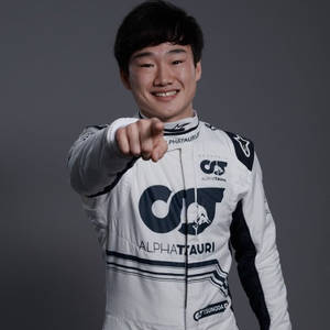 Yuki Tsunoda, Formula One Rising Star, Smiling And Pointing Forward Wallpaper