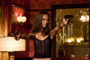 Zoe Saldana Holding Handgun Wallpaper