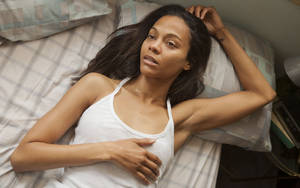 Zoe Saldana Lying On Bed Wallpaper